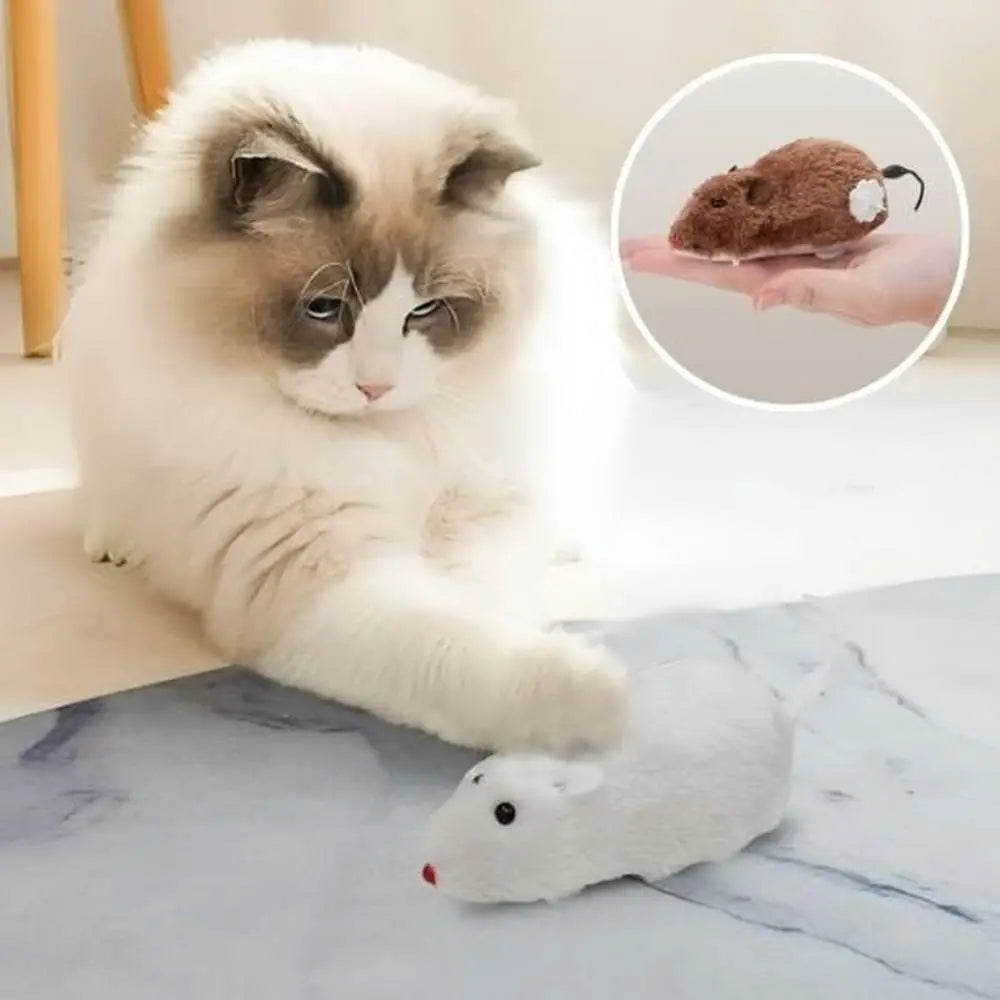 Souris en peluche Stimu'Félin blanche, museau rouge et queue courbée.