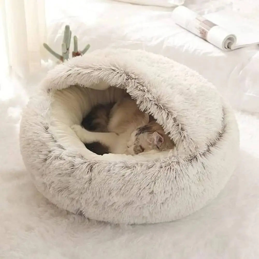 Panier pour chat Cocooning rond en peluche claire, intérieur rembourré visible.
