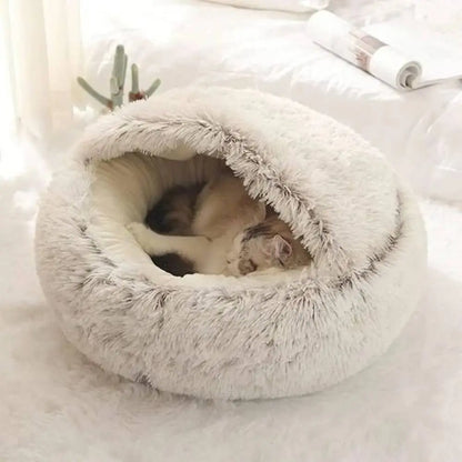Panier pour chat Cocooning rond en peluche claire, intérieur rembourré visible.