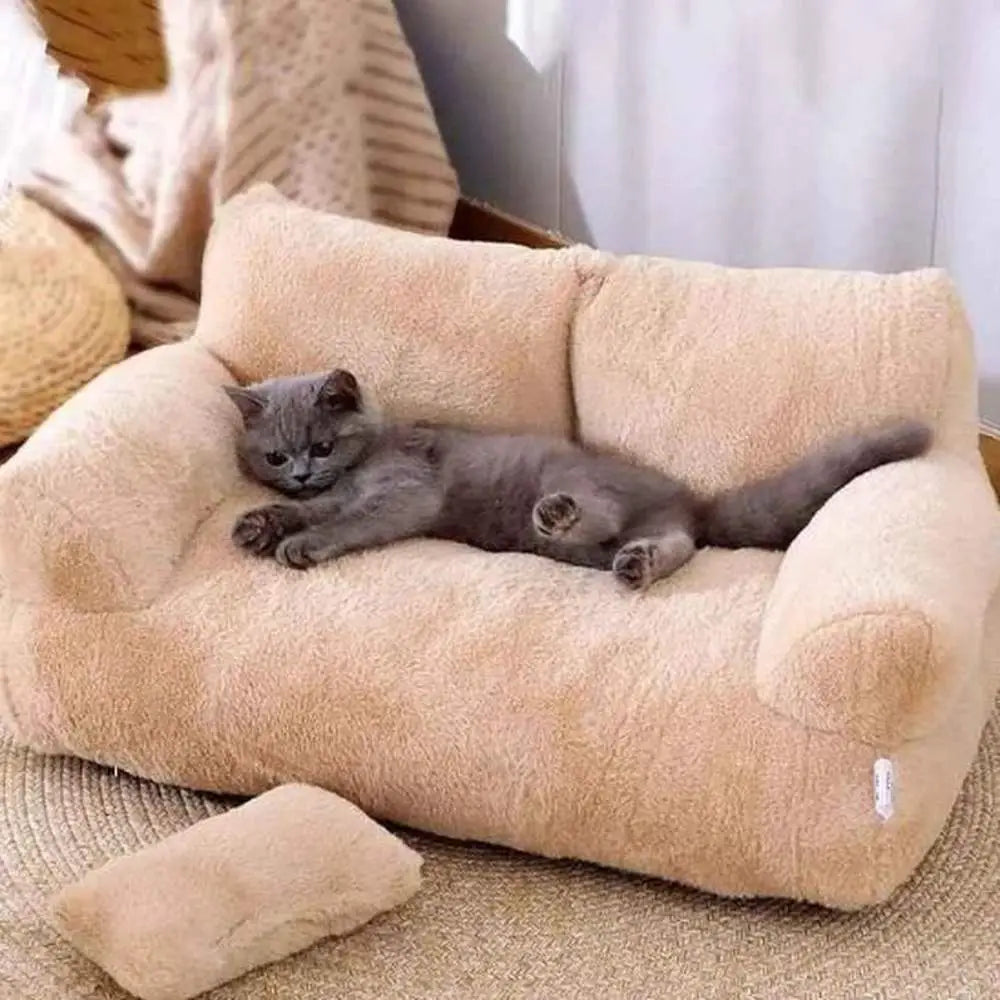 Panier pour chat en peluche beige, rebords rembourrés en U, chat gris allongé.