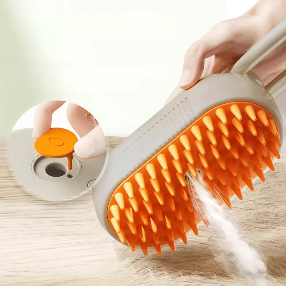 Brosse vapeur pour chat avec tête orange à picots, vapeur et coussin à l’arrière