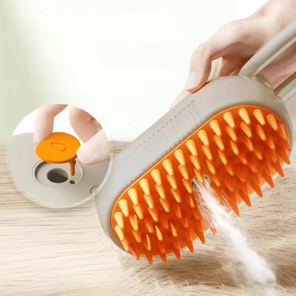 Brosse vapeur pour chat avec tête orange à picots, vapeur et coussin à l’arrière