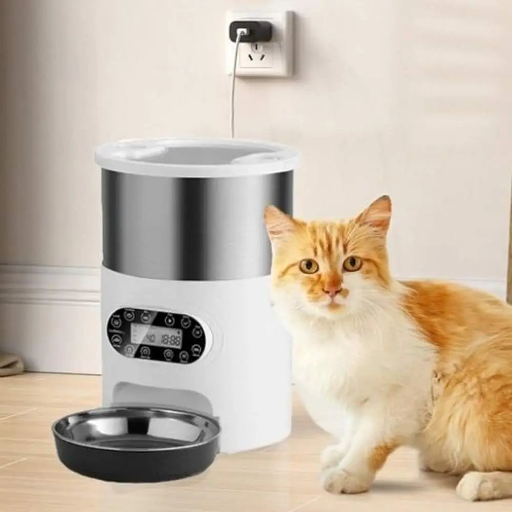 Distributeur croquettes SmartFeeder blanc/acier, bol noir ouvert.
