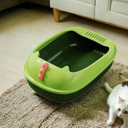 Bac à litière pour chat vert foncé avec bord vert, couvercle et pelle roses, litière visible.