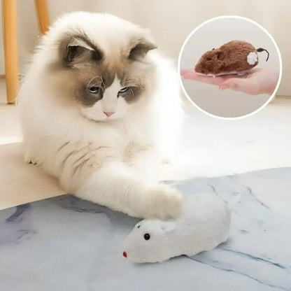 Souris en peluche Stimu'Félin blanche, museau rouge et queue courbée.